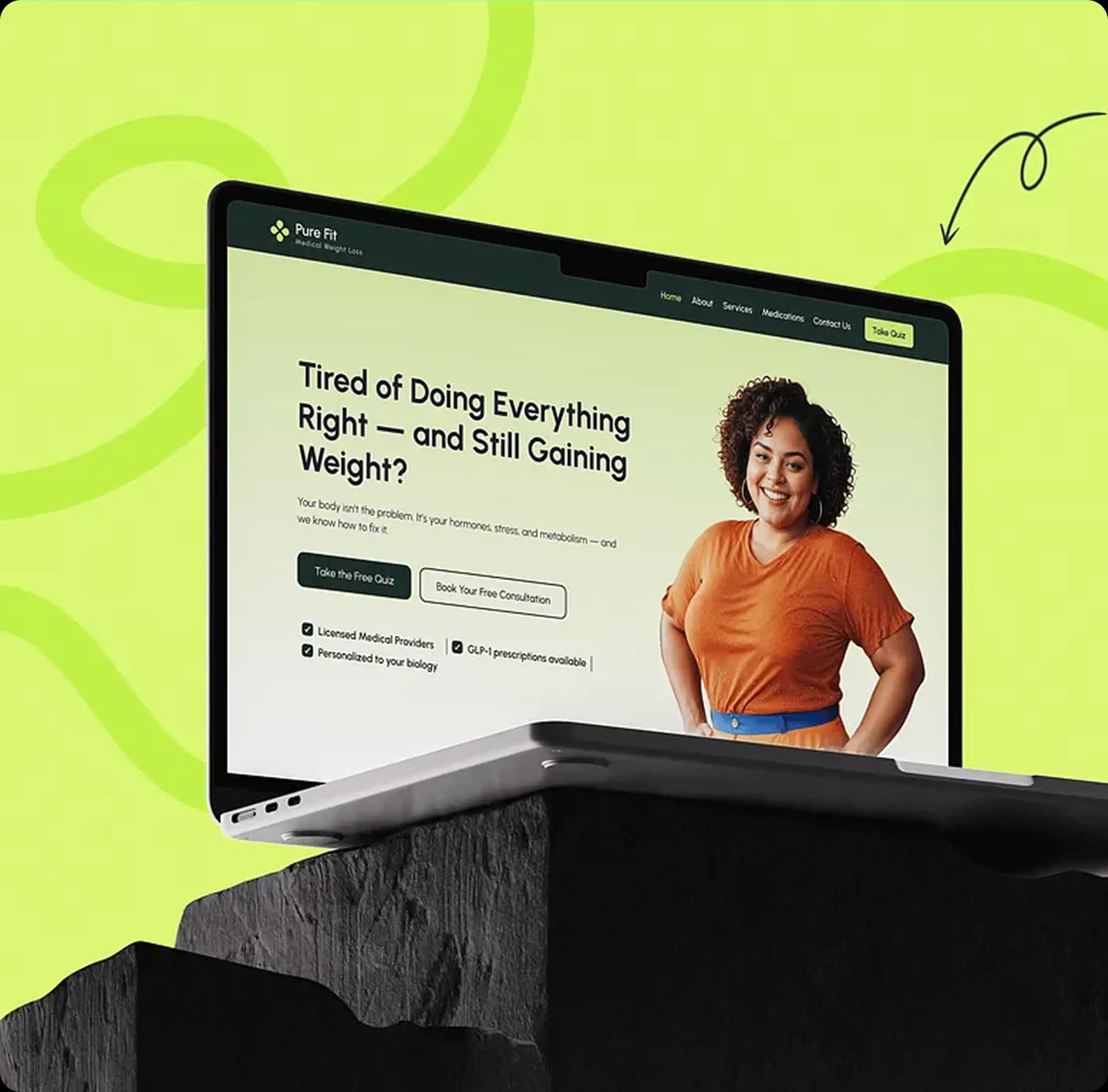 Laptop on black rock showing Pure Fit website with a smiling woman in an orange shirt and text about weight gain and medical weight loss services.