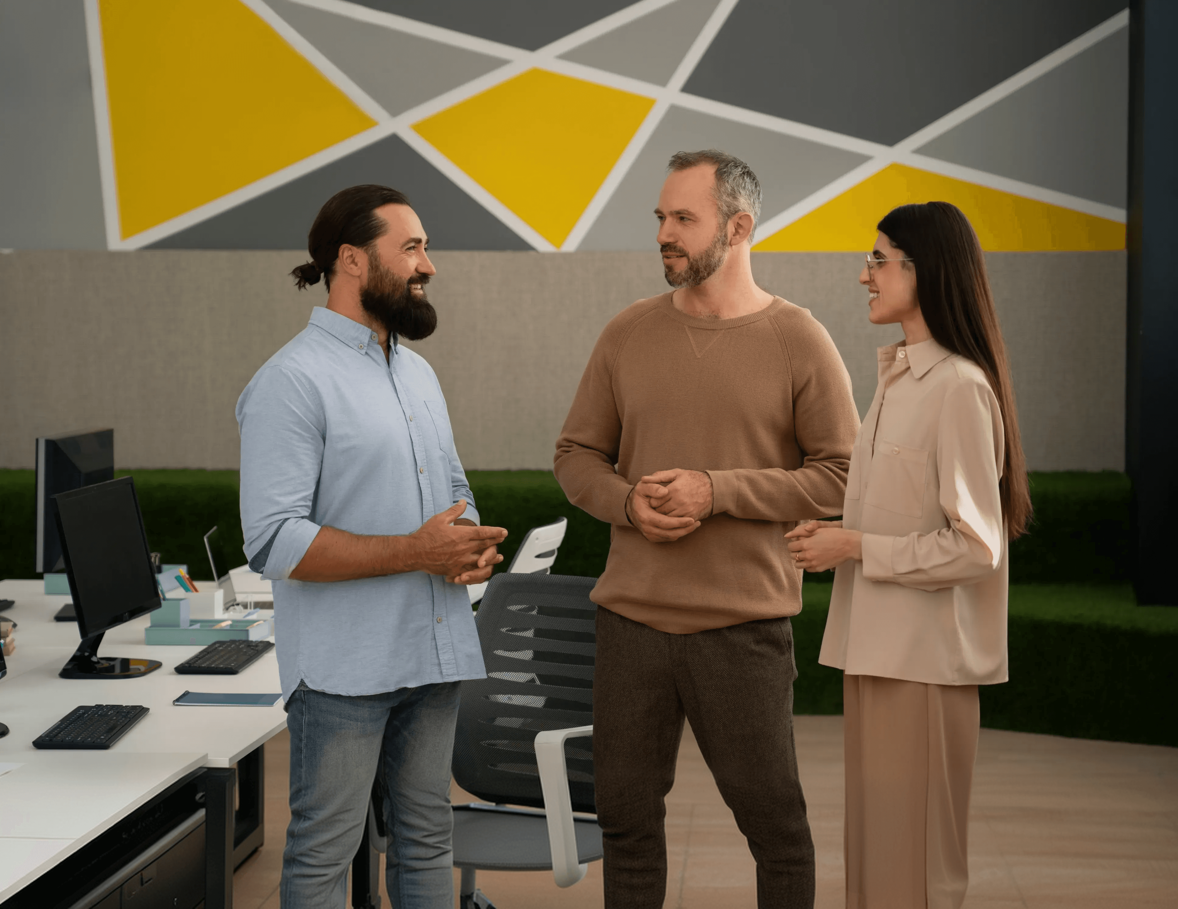 Colleagues talking through a new request in a bright, modern office.