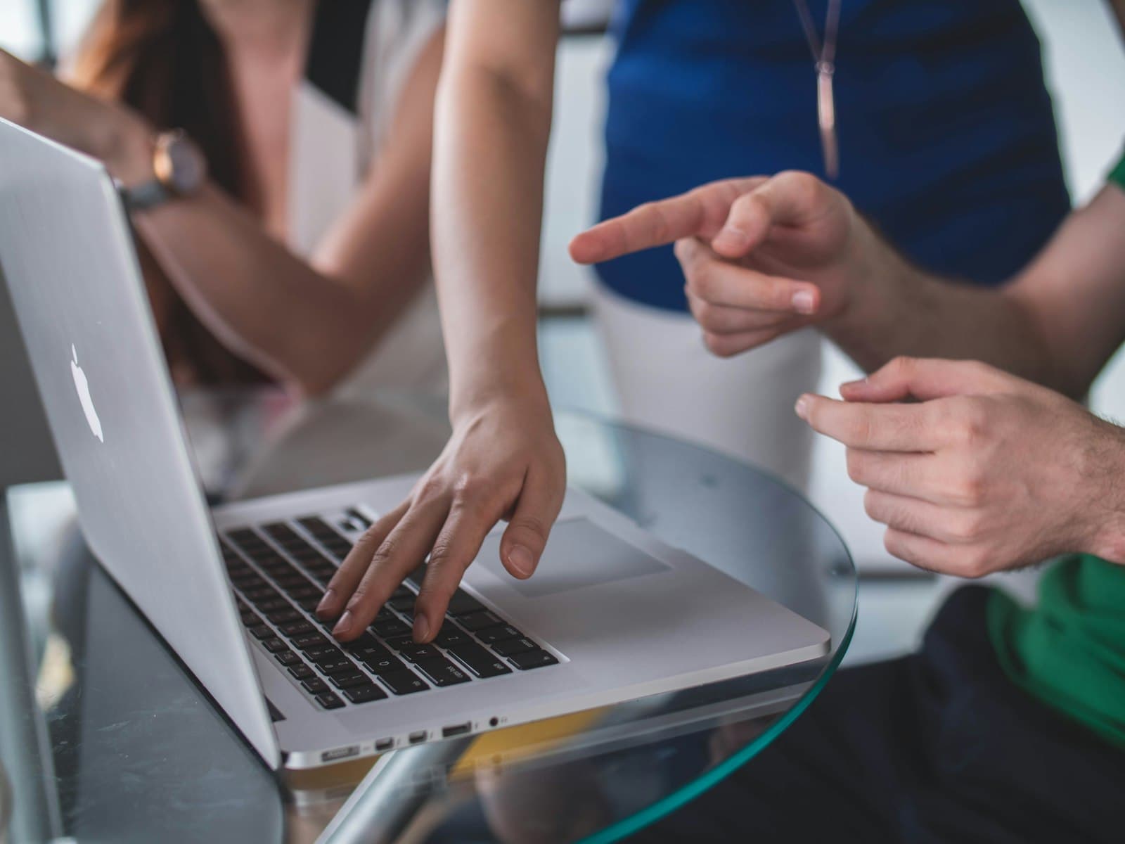 Team pointing at a laptop screen together