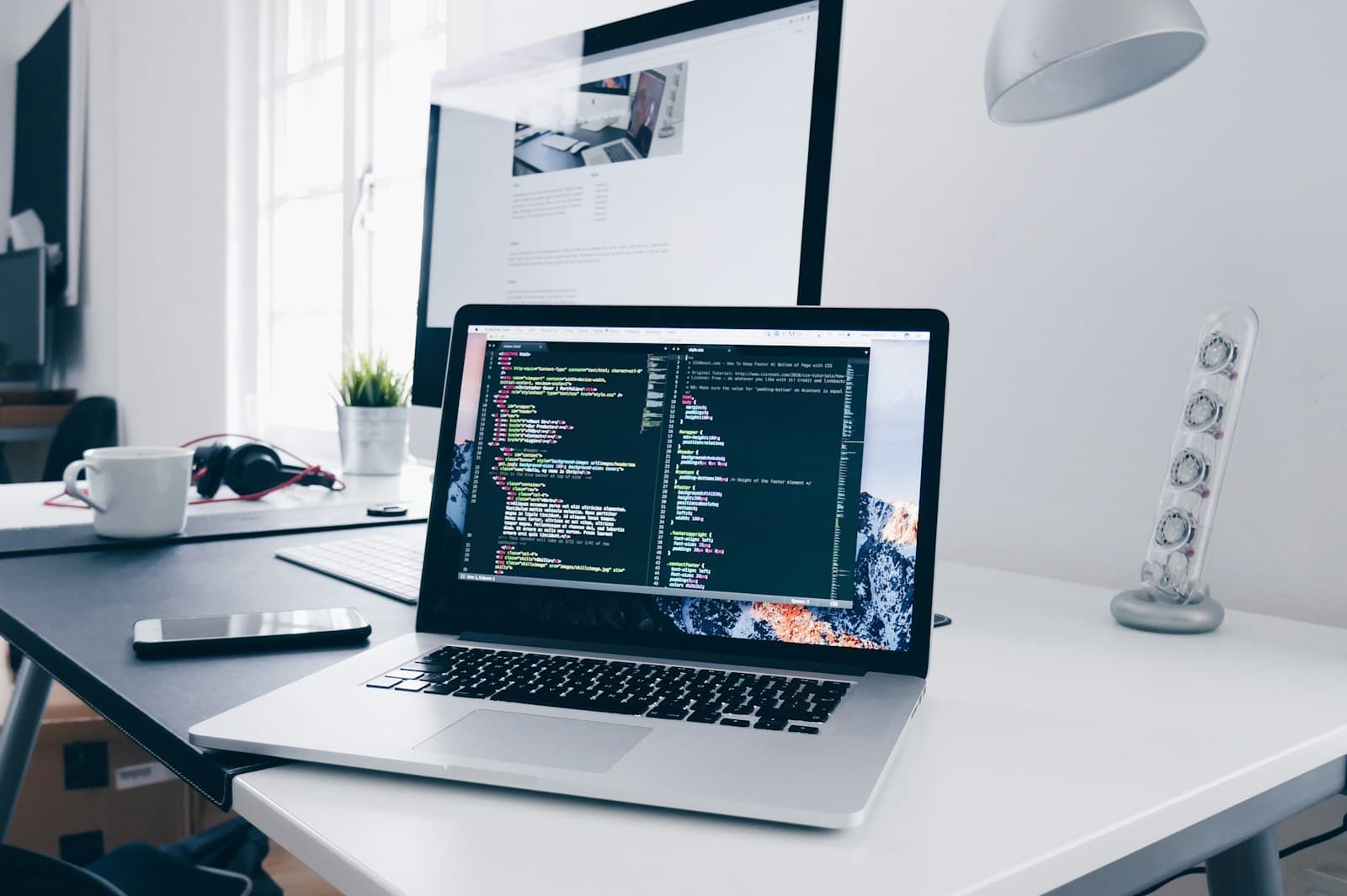 Laptop on a clean desk showing a site being built