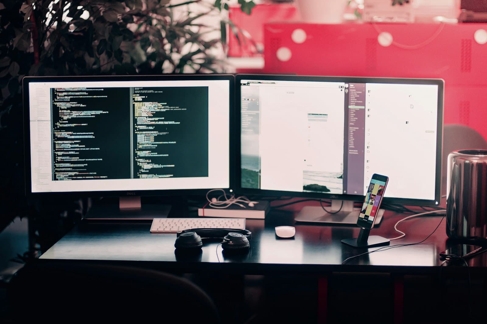 Two monitors with code and a page preview