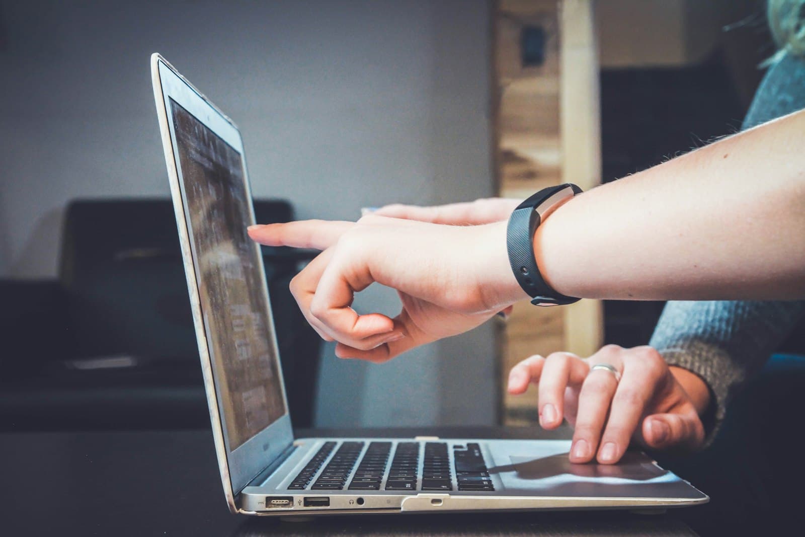 Colleagues pointing at a page on a laptop