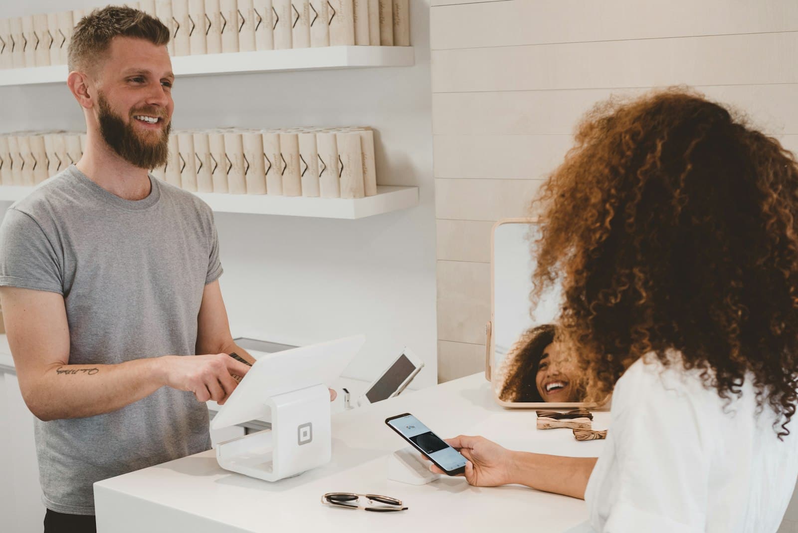 Shop owner taking a mobile payment from a customer