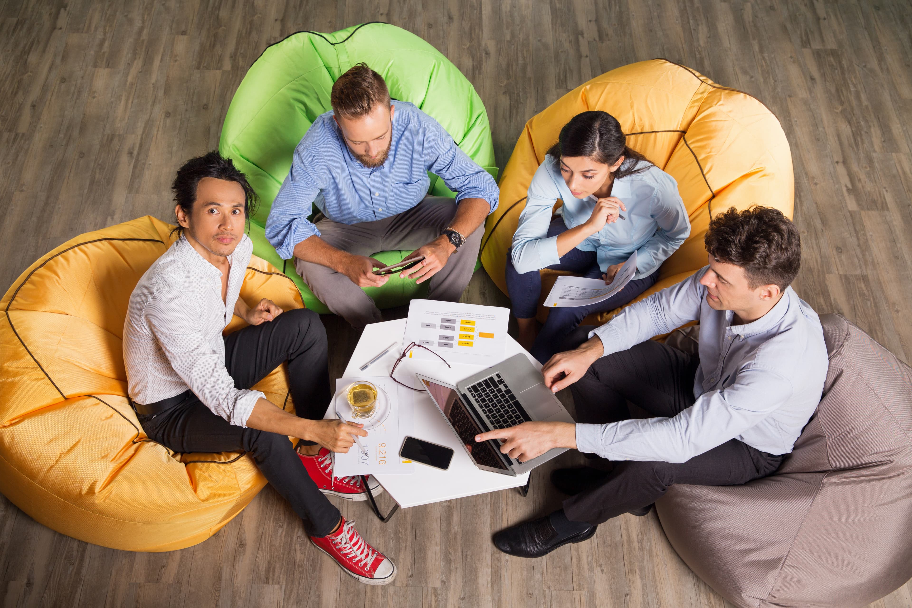 Cozmiq teammates gathered together, reviewing project notes