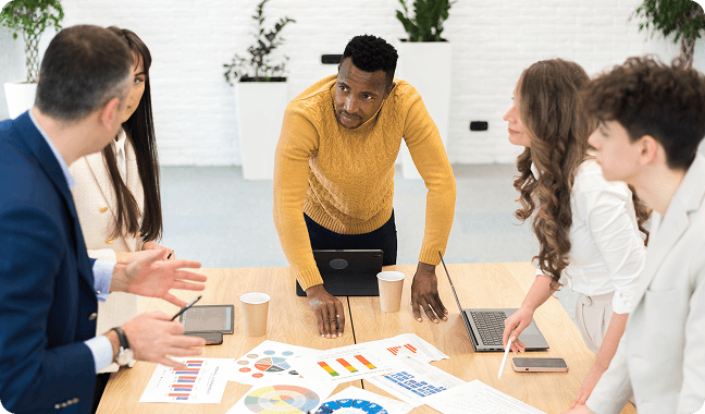 Team gathered around a table collaborating on strategy and design during a discovery session.